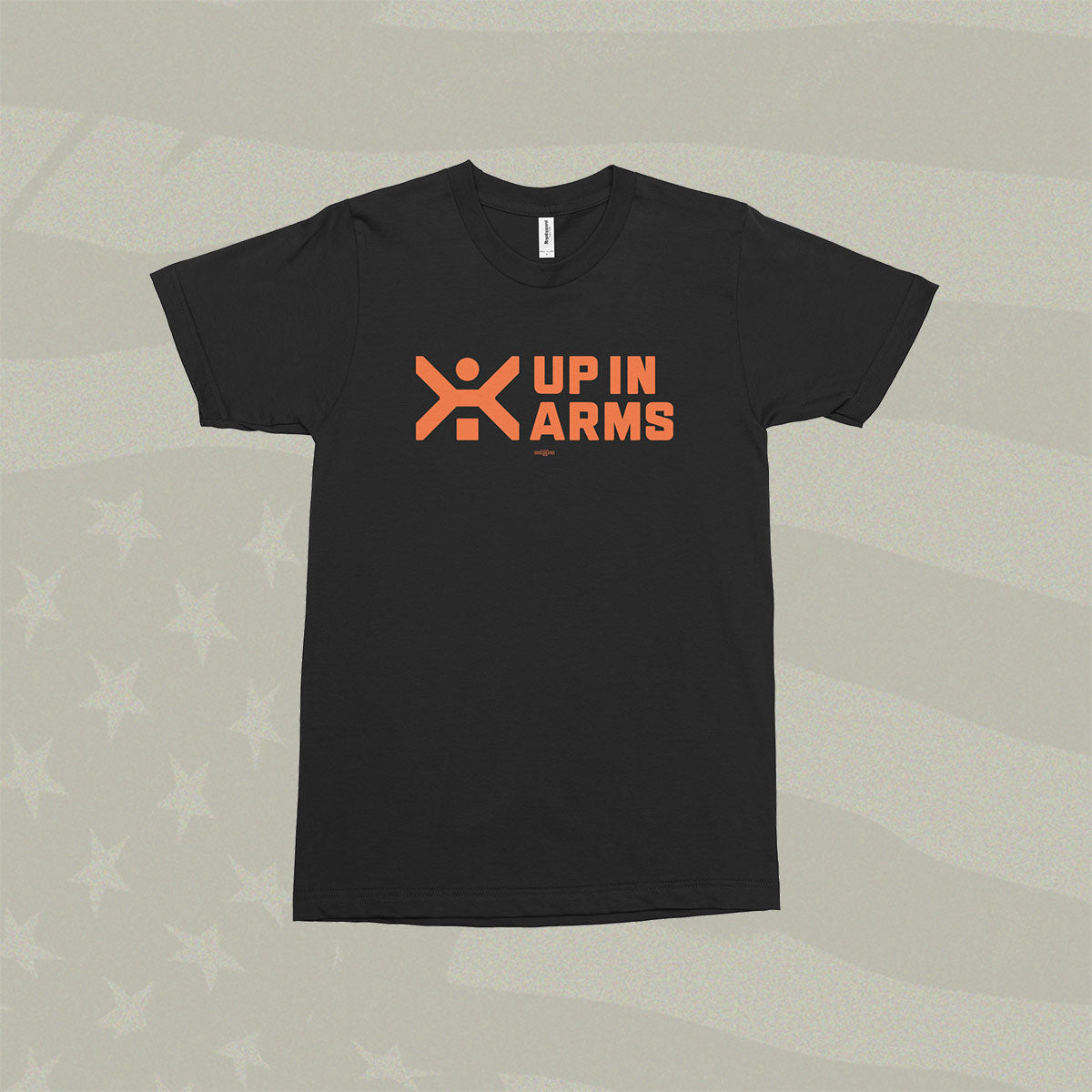 Black t-shirt with orange logo and text on a textured gray background